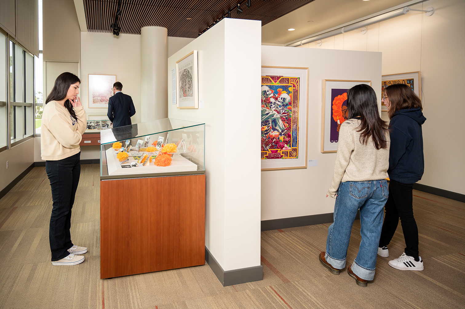 several people attending an exhibit of art and materials