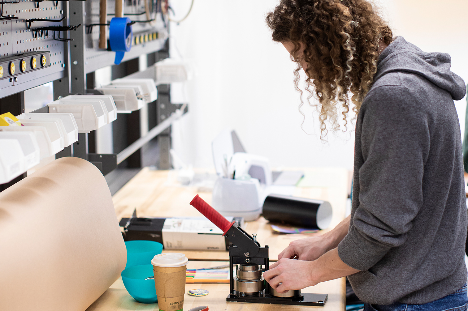 person standing at a workbench working on a project